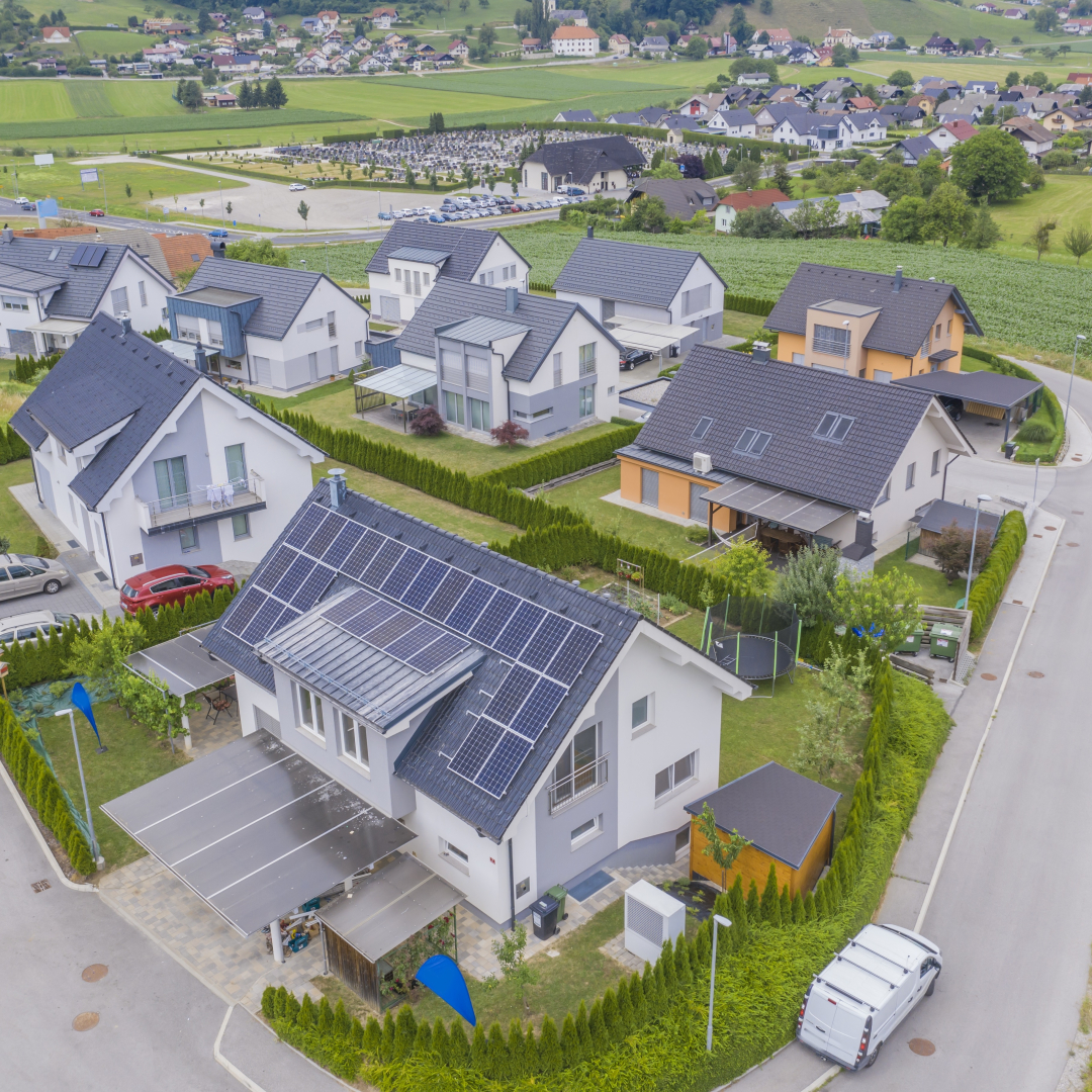 High angle shot of private houses with solar panels on the roofs Question Image